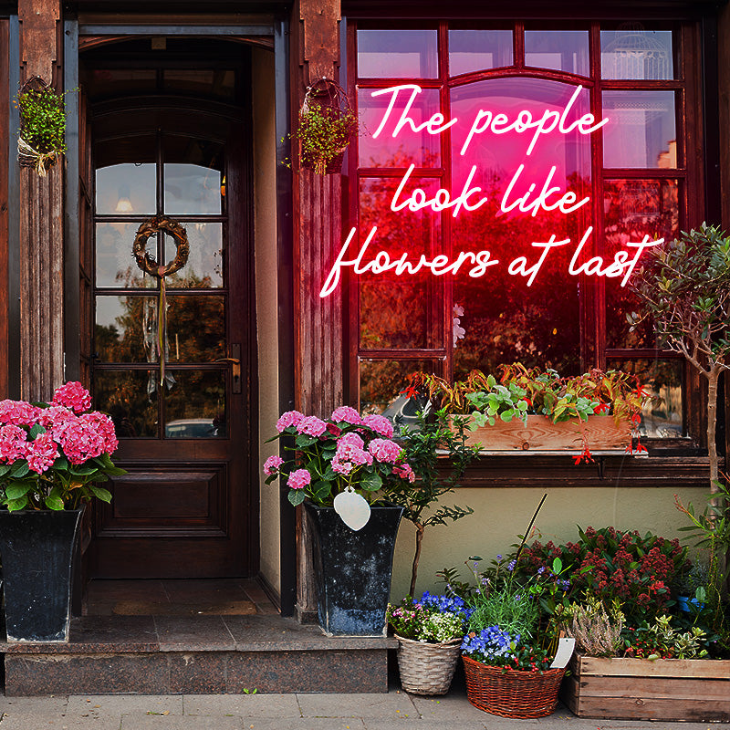The people look like flowers at last neon sign
