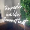 The people look like flowers at last neon sign
