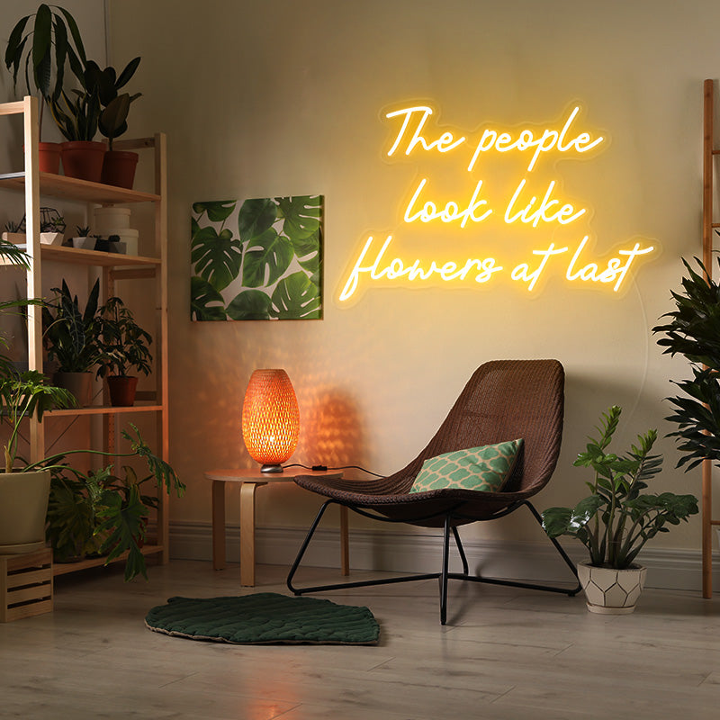 The people look like flowers at last neon sign
