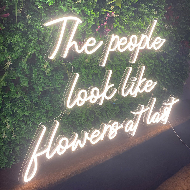 The people look like flowers at last neon sign